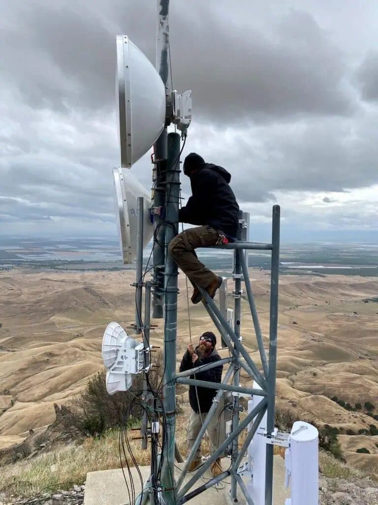 Succeed.Net technician working on a tower above the Sacramento Valley